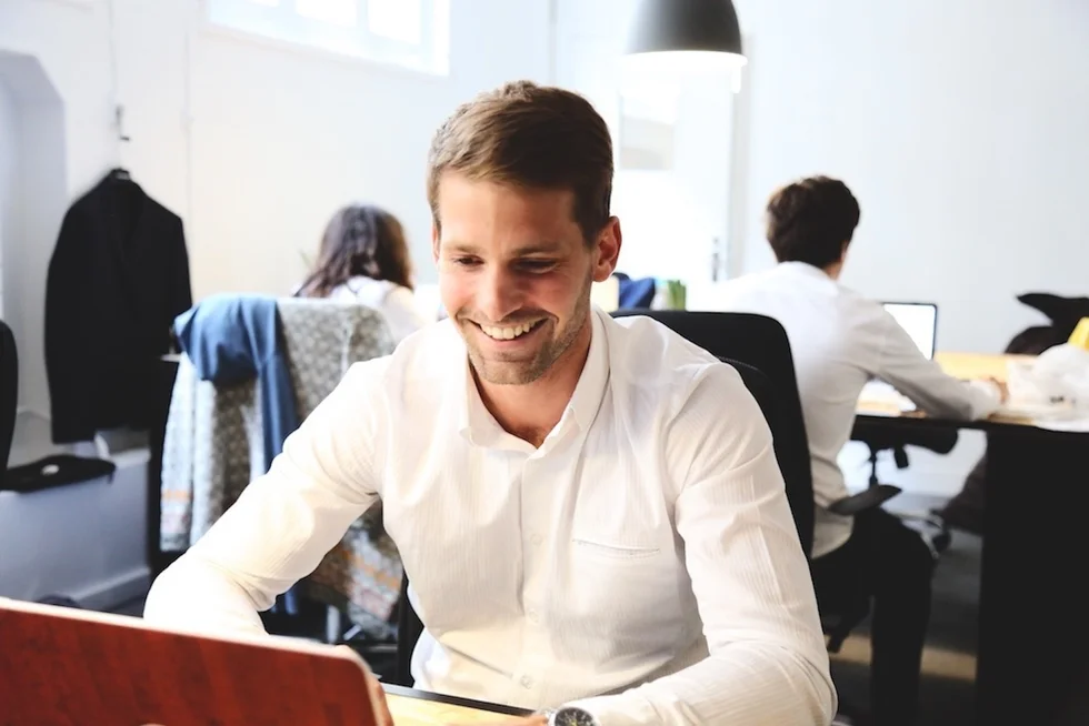 Qualified accountant reviewing blockchain financial data on multiple screens in modern office